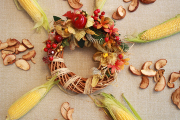 Fall composition for thanksgiving day with corn,apple,mushrooms and pumpkin.