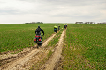 Bicyclists in roughed field in Nizhny Novgorod Region, Russia