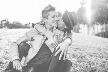 Happy female gay couple kissing and having fun together outdoor