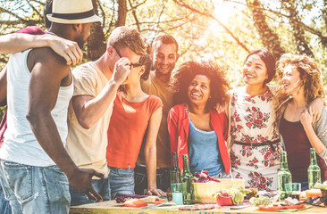 Group of happy friends having fun at barbecue party outdoor into the wood nature