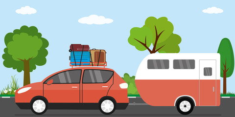 Modern red car with luggage on roof and caravan