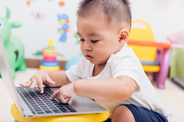 Child baby boy working using laptop computer