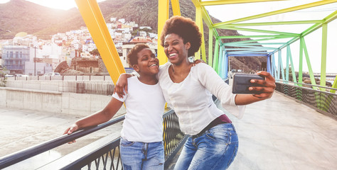 Obraz premium Happy young mother having fun with her child in summersunny day