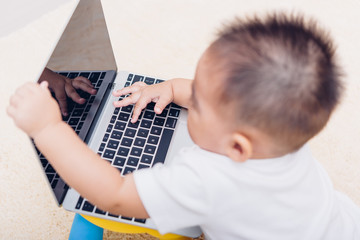 Fototapeta na wymiar Child baby boy working using laptop computer