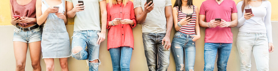 Group of millennials friends watching smart mobile phones