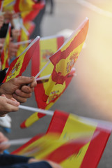 Spain flags held by people
