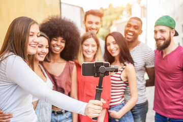 Happy millennials friends making video feed with smartphone outdoor