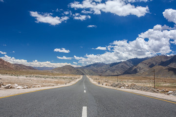 Emty road vanishing into HImalayas mountains in Ladakh, Northern India. Road trip concept