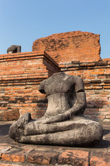 Detail of many headless Buddhas along a temple wall at Wat Mahathat, Temple of the Great Relic, in Ayutthaya, Thailand