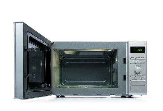 Microwave oven with door open, isolated on white background.