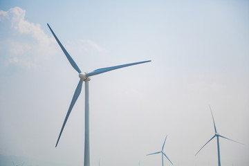 Fototapeta premium Wind Farm Turbines - Renewable Clean Green Energy. Power Generating Wind Turbines