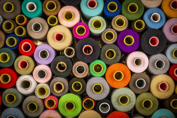 From above set of sewing spools with colorful threads