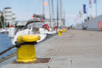 Harbor bollard for large naval vessels. The port wharf in central europe.
