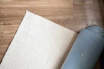 A piece of beige carpet without overlock