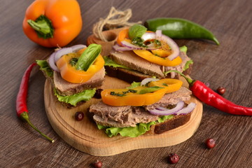 Sandwiches with boiled beef, vegetables and sauce on rye bread
