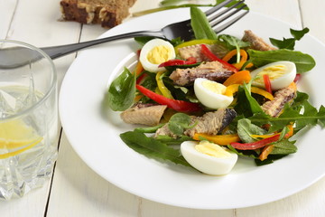 Fish salad with quail eggs, sweet peppers and fresh herbs