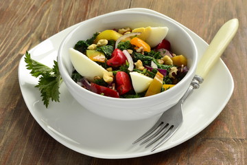 Salad with nettles, egg, sweet pepper, onion and  walnut