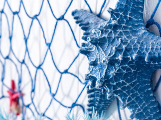 Blue net and artificial starfish made of plastic on the wall decoration