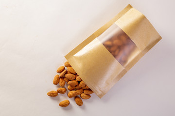 Almonds packed in paper bags on a white background.