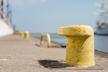 Harbor bollard for large naval vessels. The port wharf in central europe.