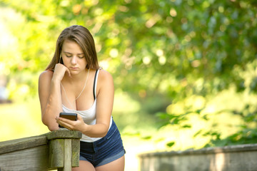 Fototapeta premium Teenage girl with headphones listening to her phone