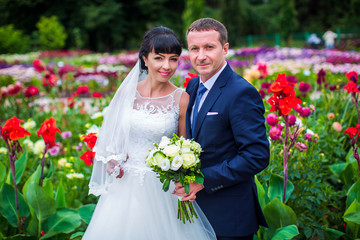 Portrait of wedding couple,on background of flowering flowers