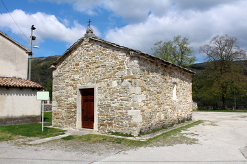 Fototapeta premium Old small completely renovated and preserved traditional stone chapel on a sunny, but cloudy day
