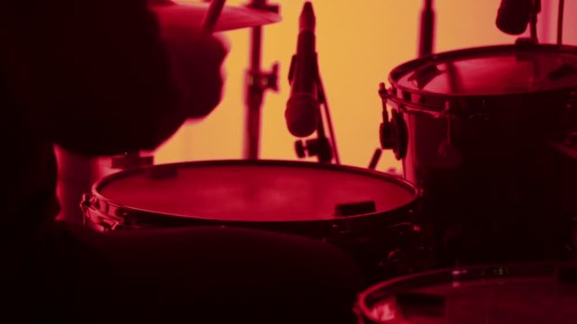 Drummer at concert in red light