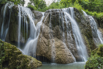 Obraz premium soft water of the stream in the natural park, Beautiful waterfall in rain forest