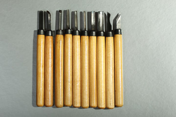 Set of wood carving knives on a gray background
