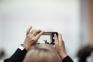 a girl with the phone in her hands make photo