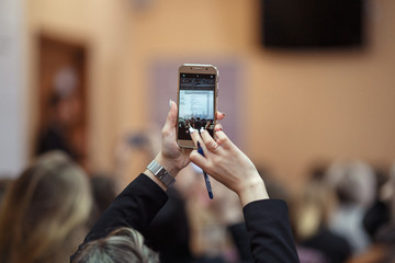 a girl with the phone in her hands make photo