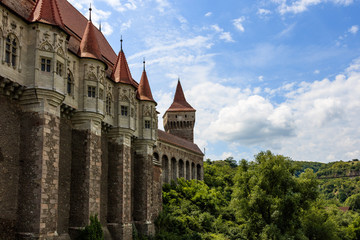 Corvin Castle, also known as Hunyadi Castle in Hunedoara, Romania.  The 400 years old magnificent Corvin Castle on a sunny day with fluffy clouds.