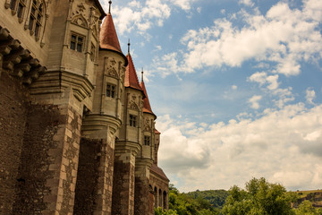 Corvin Castle, also known as Hunyadi Castle in Hunedoara, Romania.  The 400 years old magnificent Corvin Castle on a sunny day with fluffy clouds.