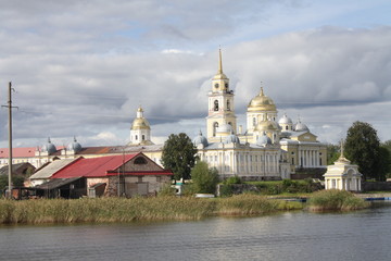 Stolobny island, Nilov Monastery, Seliger lake in Russia seen from the lake, churches, clouds