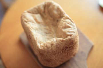 a loaf of home bread on a wooden cutting board