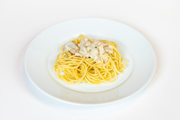 cooked spaghetti with carbonara sauce on white plate