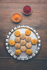 brown and Kesar Pedha or Peda is an Indian traditional sweet dish made from milk/khoya and saffron