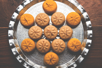 brown and Kesar Pedha or Peda is an Indian traditional sweet dish made from milk/khoya and saffron