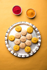 brown and Kesar Pedha or Peda is an Indian traditional sweet dish made from milk/khoya and saffron