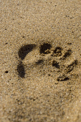 footprint in golden sand, corfu, greece