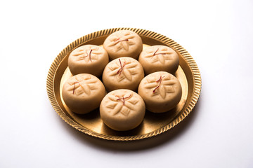 brown and Kesar Pedha or Peda is an Indian traditional sweet dish made from milk/khoya and saffron