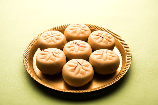 brown and Kesar Pedha or Peda is an Indian traditional sweet dish made from milk/khoya and saffron