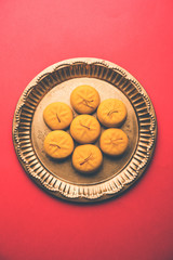 brown and Kesar Pedha or Peda is an Indian traditional sweet dish made from milk/khoya and saffron