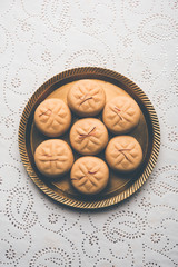 brown and Kesar Pedha or Peda is an Indian traditional sweet dish made from milk/khoya and saffron