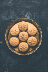 brown and Kesar Pedha or Peda is an Indian traditional sweet dish made from milk/khoya and saffron