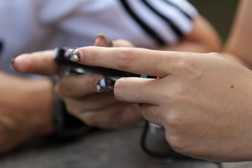 Fototapeta na wymiar Female hand playing on a portable game device.