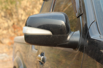 Black side rear-view mirror of pickup truck. © noomcm