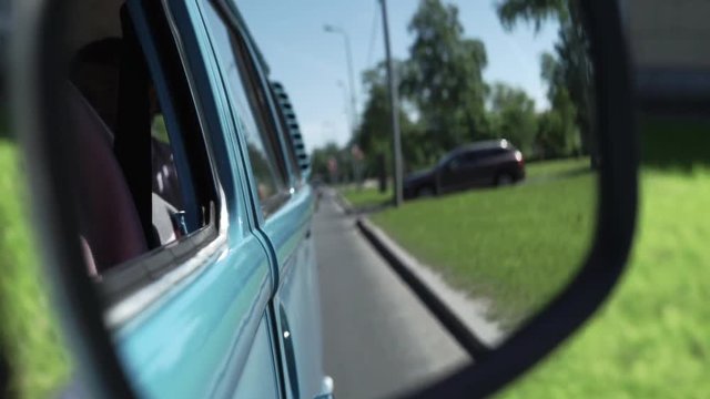 Blue retro bus driving in a city