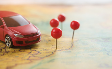 Travel and Transportation concept,Red miniature car on the map